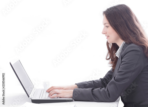 successful business woman typing on a laptop