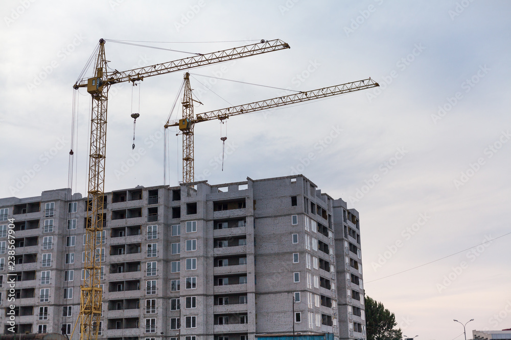 Two cranes build multi-storey house Two cranes build multi-storey house