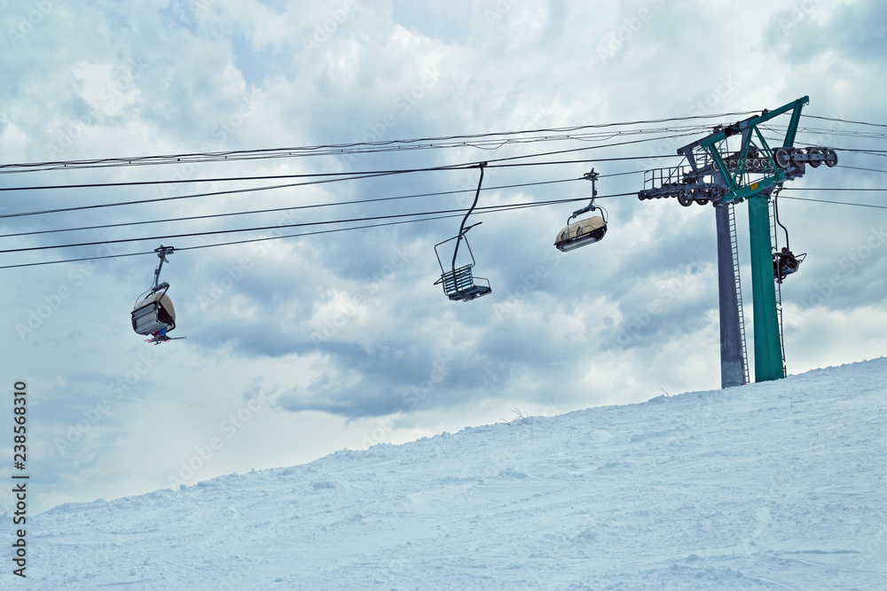Ski lift against sky. Sheregesh ski resort. Active winter holidays.