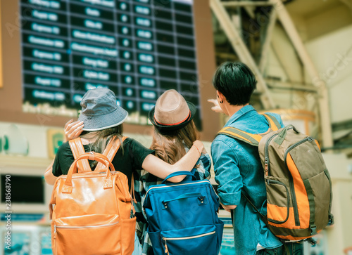 travel concept.group of traveller friend with trikets counter and time table background.