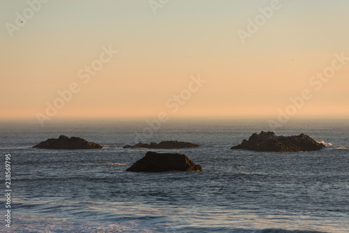 Islets protruding in the Pacific Ocean on a beach in Southern Oregon  USA