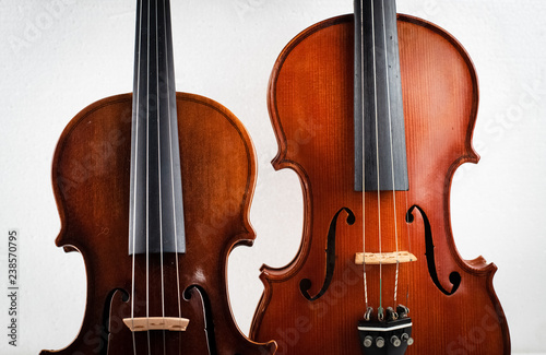 Two different size of violin put on background,show detail of front side,