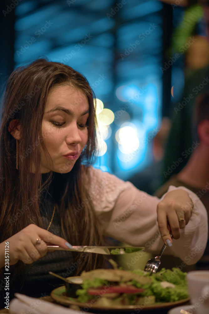 Young girl has lunch in a restaurant