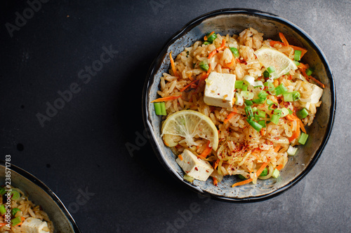 Vegetarian fried rice with tofu, peas and vegetables. Asian cuisine, healthy lunch, copy space