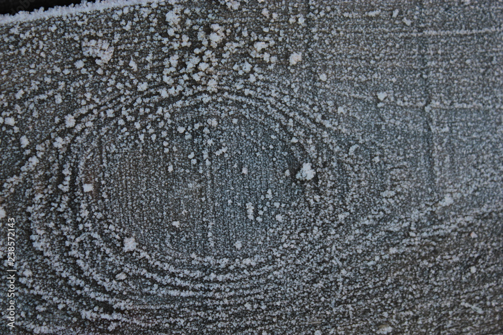 An old gray wooden board, covered with snow. An old gray wooden board, covered with snow.