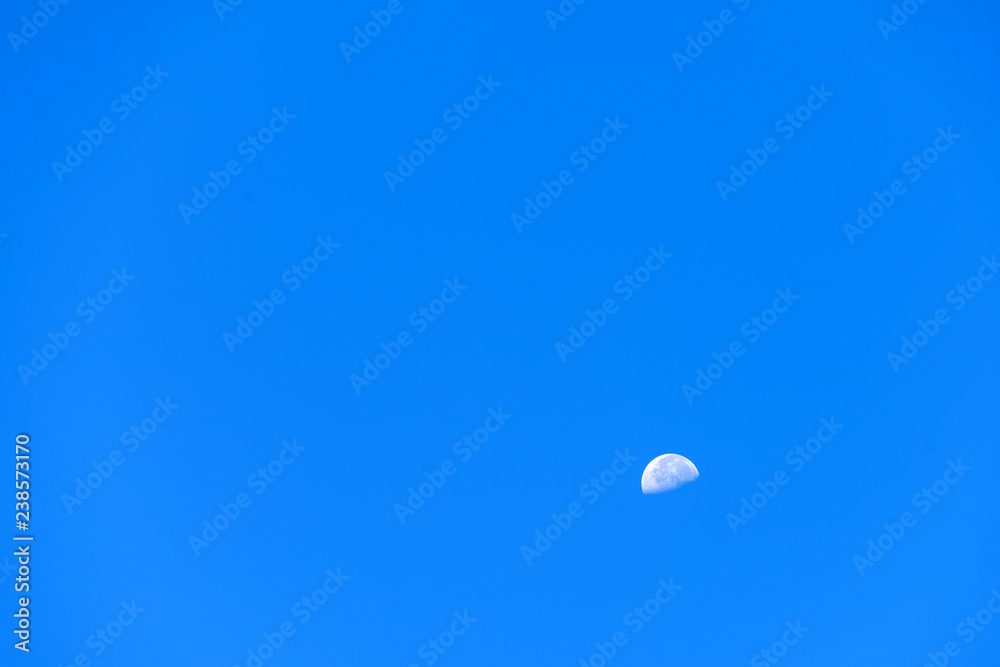 mini moon on blue sky nature background ,clear blue color , blank empty space backdrop mini moon on blue sky nature background ,clear blue color , blank empty space backdrop