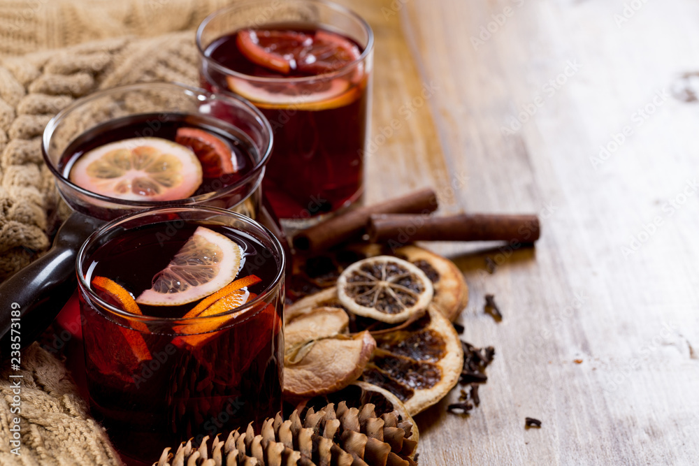 glasses of mulled wine with dry citrus and spices ,knitted sweater. glasses of mulled wine with dry citrus and spices ,knitted sweater.