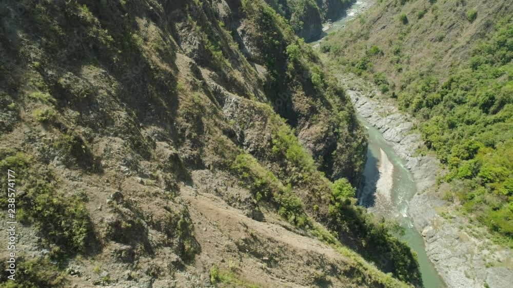 Aerial view of mountain river in the cordillera gorge, mountains covered forest, trees. Cordillera region. Luzon, Philippines. Mountain landscape. Aerial view of mountain river in the cordillera gorge, mountains covered forest, trees. Cordillera region. Luzon, Philippines. Mountain landscape.