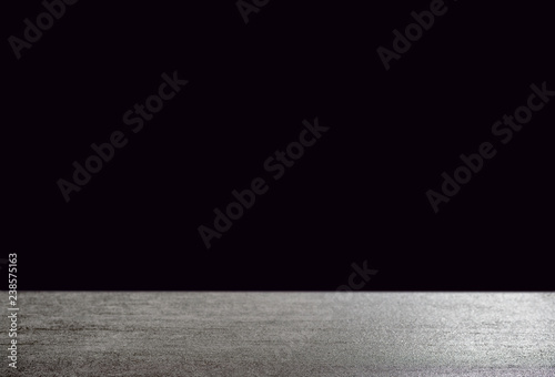 Dark background in front of grey empty stone concrete table, space for text modern look