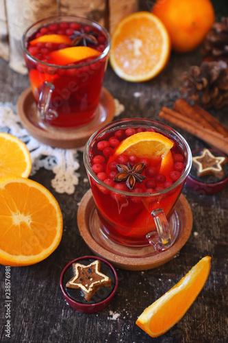 Healthy winter beverage. Cranberry fruit drink with oranges
