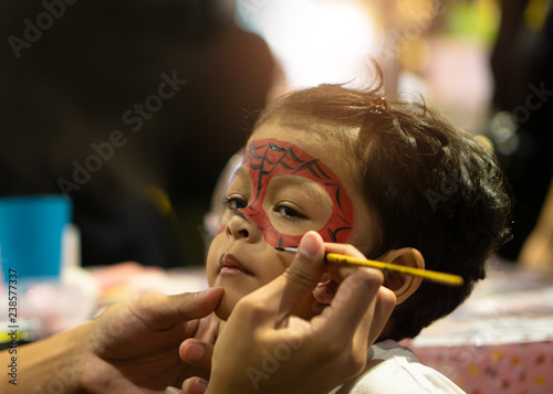 Fotografie Asian kid boy with painted face as a spider