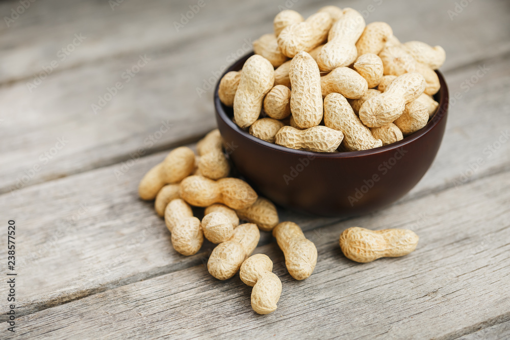 Peanuts in the shell, in a wooden cup on the table. Peanuts in the shell, in a wooden cup on the table.