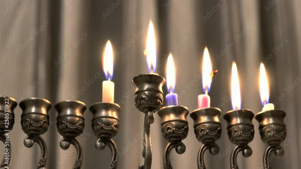 Six candles in hanukkiah are burning on light curtain background on the fifth day of the Jewish holiday Hanukkah. Selective focus, 4k Six candles in hanukkiah are burning on light curtain background on the fifth day of the Jewish holiday Hanukkah. Selective focus, 4k