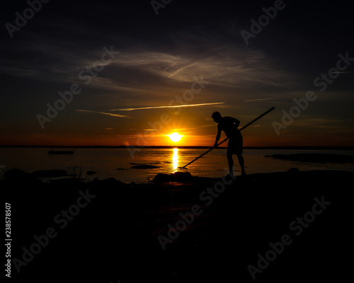 Silhouette of fisherman at sunset