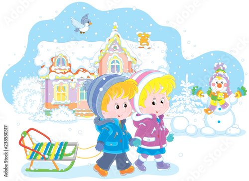 Smiling little girl and a boy walking with a small sled against a snow-covered house and a funny snowman, vector illustration in a cartoon style