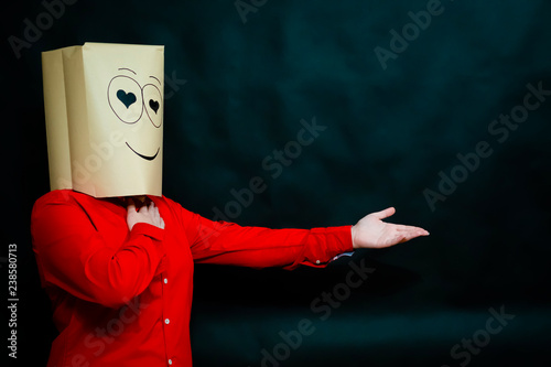 The concept of emotions. The girl in the red shirt looks at the interlocutor with loving eyes. In the eyes hearts. On the face smile and joy. The palm of the right hand is pressed to the chest.