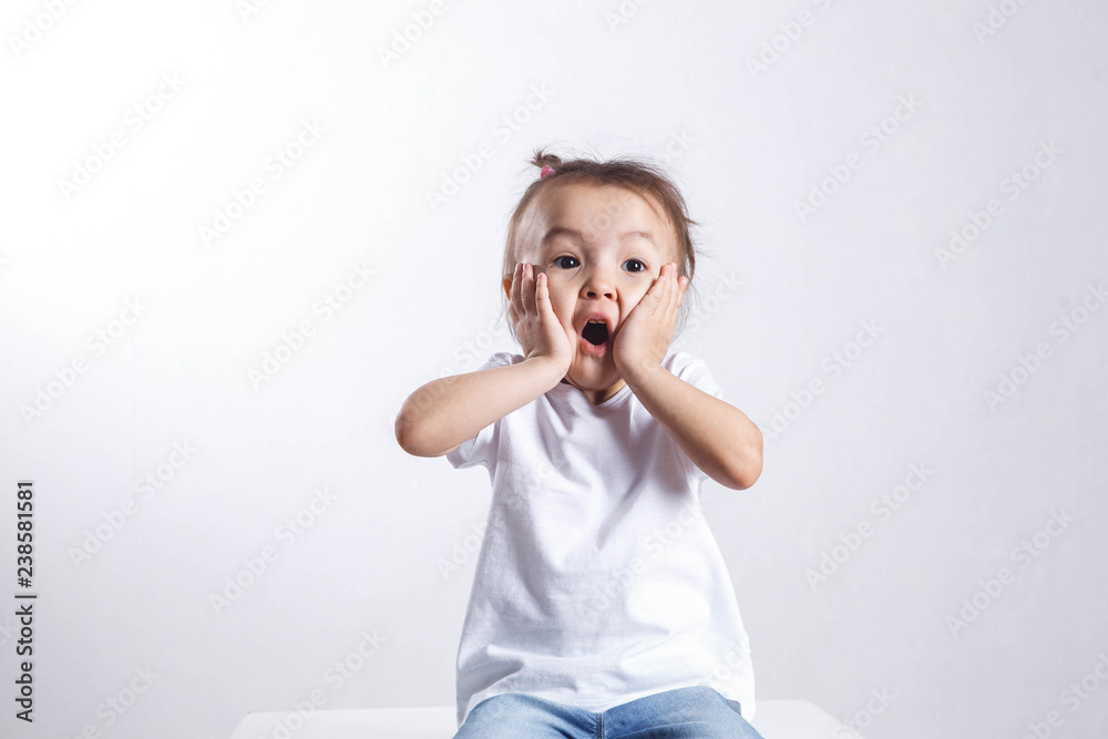 Portrait of adorable surprised little girl on a white Portrait of adorable surprised little girl on a white