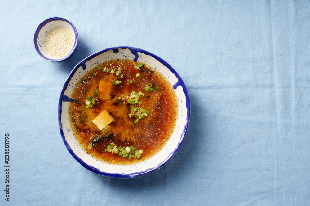 Japanese miso soup with tofu, wakame seaweed, spring onions and pepper flakes Japanese miso soup with tofu, wakame seaweed, spring onions and pepper flakes