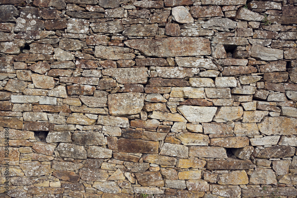 Stone wall background. Ancient wall of dry masonry. Stone wall texture in the historic city of Santiago de Compostela Stone wall background. Ancient wall of dry masonry. Stone wall texture in the historic city of Santiago de Compostela