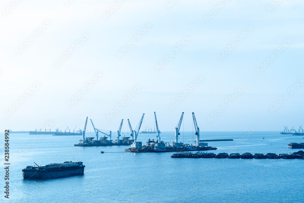 landscape of Cargo ships or Tanker trucks entering one of the busiest ports the Asia in morning. import,export logistic industrial Transportation concept