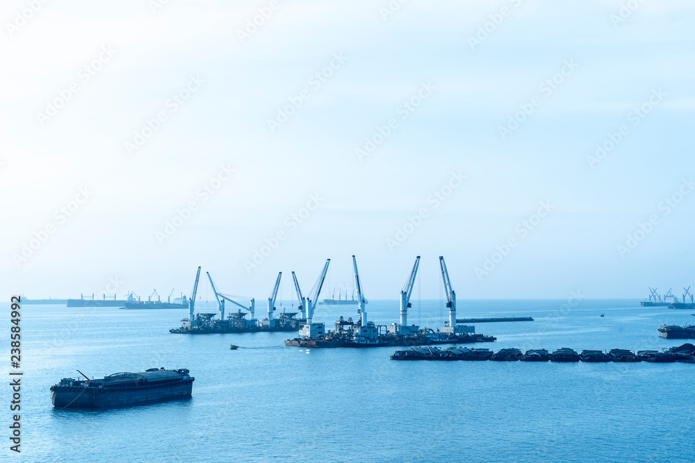 landscape of Cargo ships or Tanker trucks entering one of the busiest ports the Asia in morning. import,export logistic industrial Transportation concept landscape of Cargo ships or Tanker trucks entering one of the busiest ports the Asia in morning. import,export logistic industrial Transportation concept