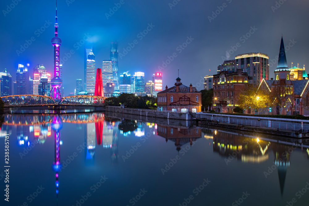Shanghai city skyline at night with Old and New town comparison near by river front.