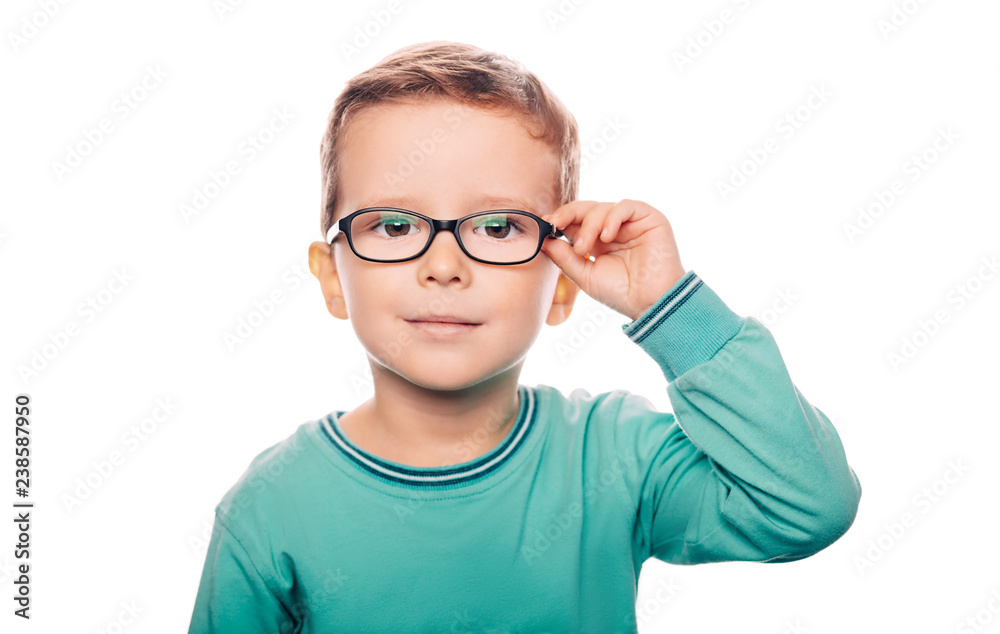 Little boy with eyeglasses isolated on white background. Vision correction for children