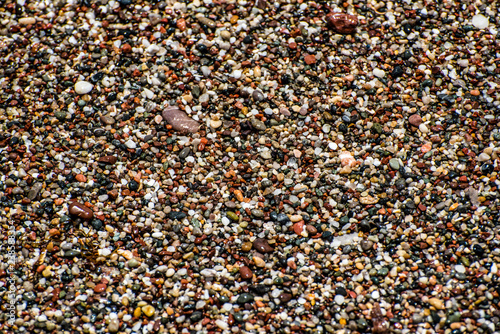 Multiple coloured pebbles. Background. Natural photo.
