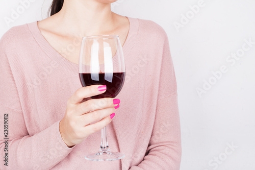 Girl holding a glass of red wine photo