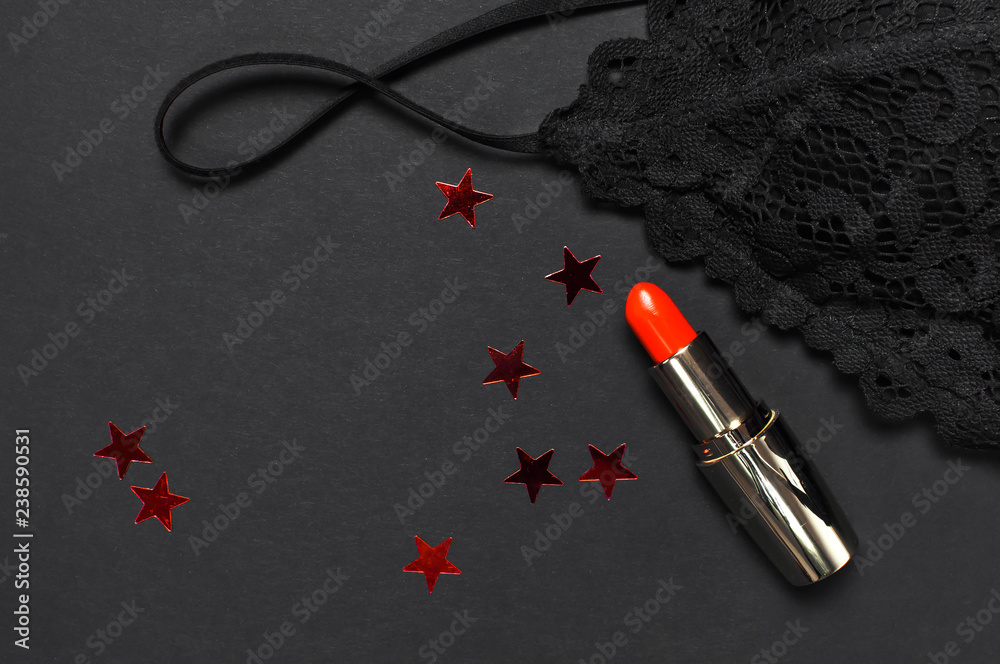 Black lace bra underwear, red lipstick, holographic confetti on dark  background top view flat lay. Female essential erotic accessories,  fashionable underwear, gift for birthday new year christmas Stock Photo