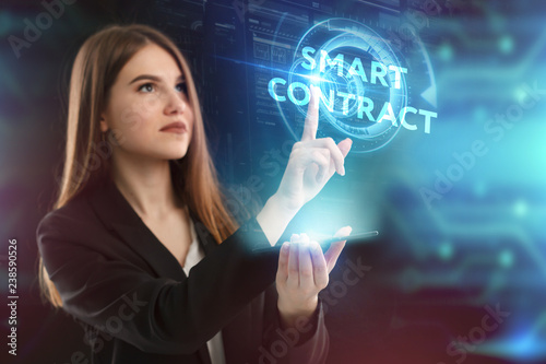 The concept of business, technology, the Internet and the network. A young entrepreneur working on a virtual screen of the future and sees the inscription: smart contract