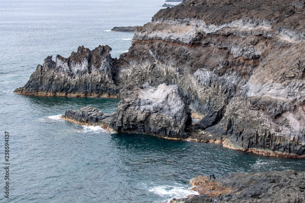 Volcanic basalt columns into the Atlantic Ocean on the coastline of La Palma Island