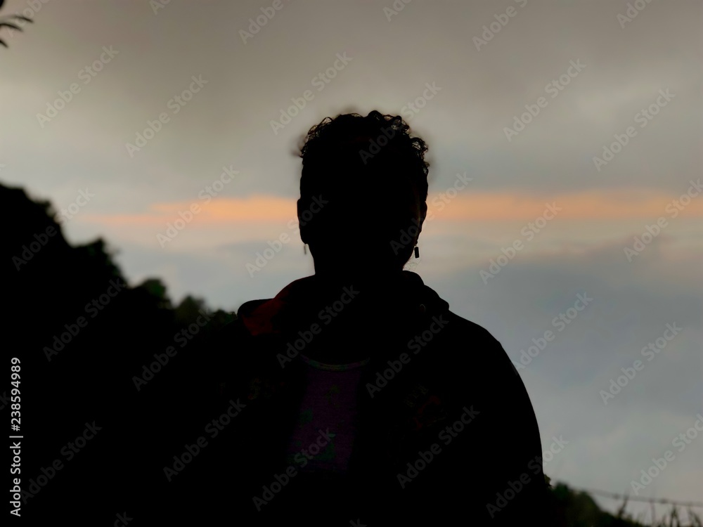 silhouette of woman in sunset