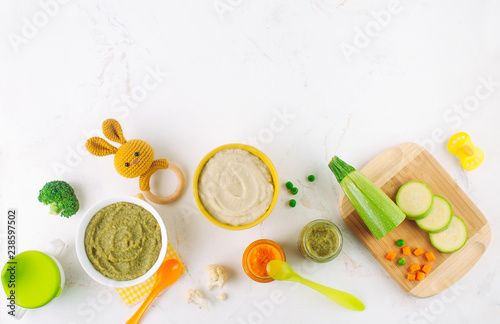 Different types of vegetable puree on the light marble background