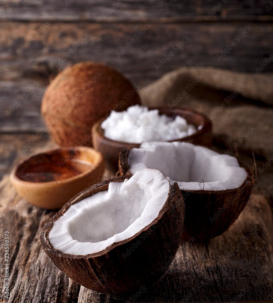 Coconut with Coconut oil on a wooden background Coconut with Coconut oil on a wooden background