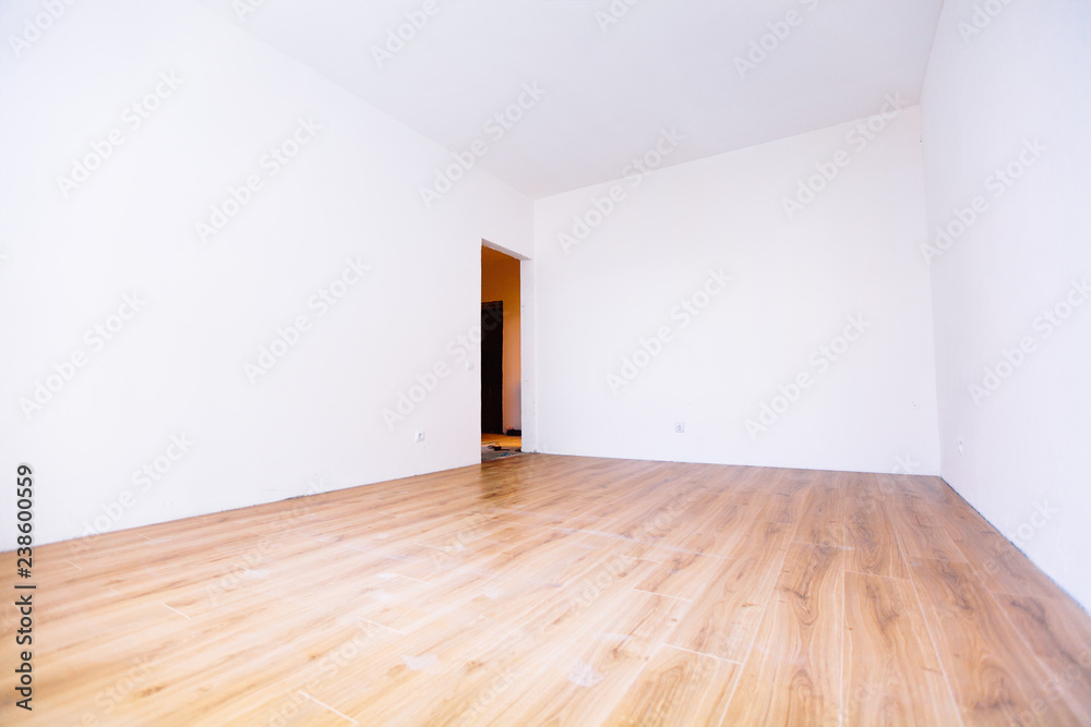 Photo of a white empty scandinavian room interior with wooden floor and walls. Photo of a white empty scandinavian room interior with wooden floor and walls.