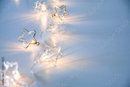 A stars shaped christmass garland on the table. Space for text