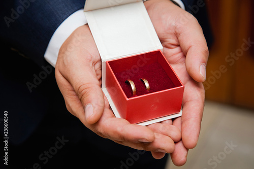 hands holding a box with ring