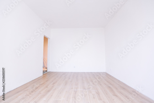 Photo of a white empty scandinavian room interior with wooden floor and walls.