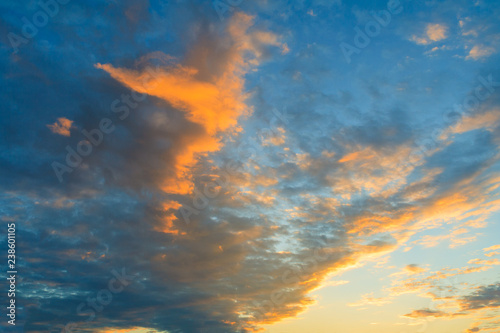 Dramatic view on a orange clouds in dark evening sky