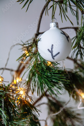 Christmas black and white toy among fir branches