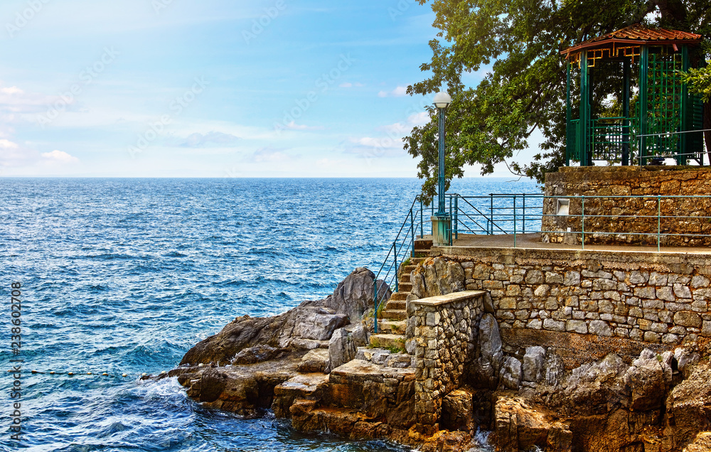 Lovran, Croatia. Rocky stone coastline with big rocks pavilion