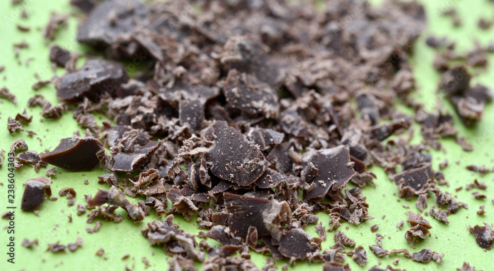 dark chocolate crumbs on green background,shallow dof dark chocolate crumbs on green background,shallow dof