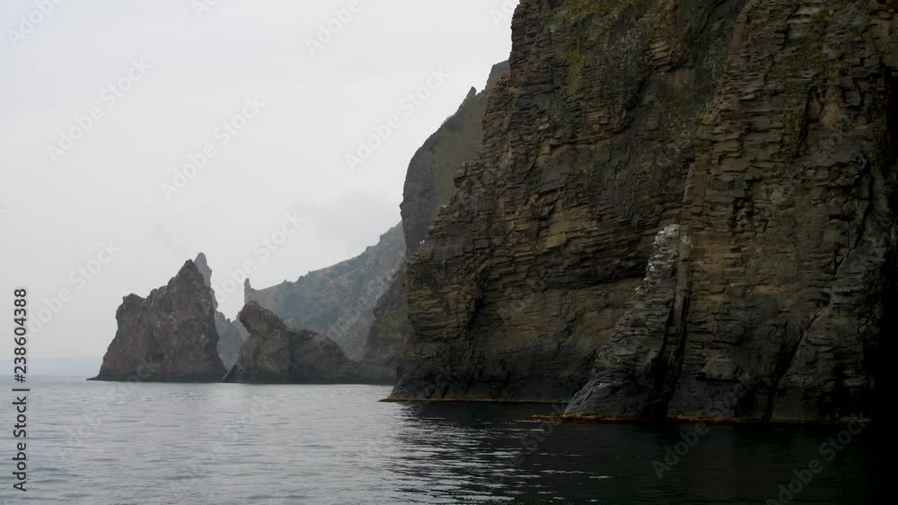 tourist boat trip along the rocks of an ancient volcano tourist boat trip along the rocks of an ancient volcano