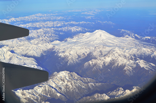 The view from the window of an airplane over the mountains of the Caucasus