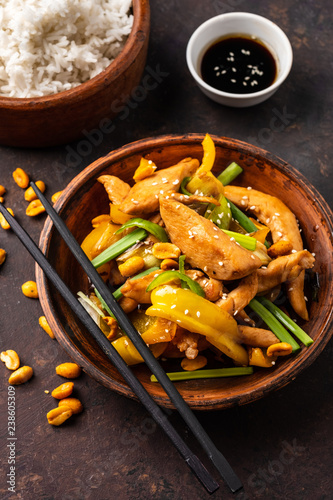 Kung Pao chicken, stir-fried Chinese sichuan traditional sichuan dish with chicken, peanuts, vegetables and chili peppers.