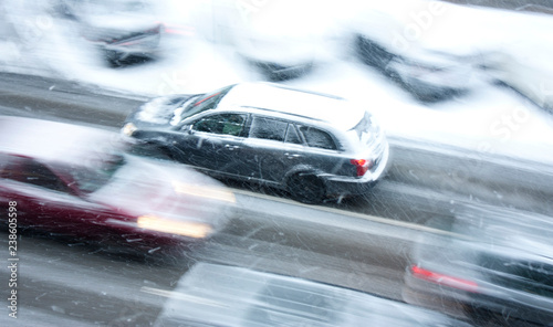 Driving cars on the snowy city street in motion blur