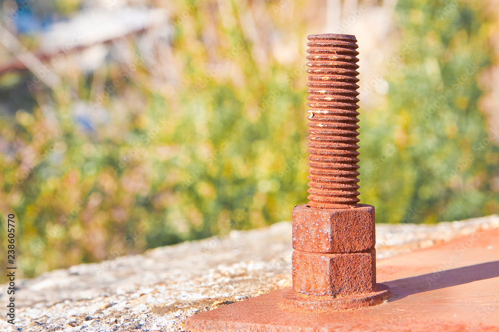 Old rusty anchor bolt with iron plate - image with copy space Old rusty anchor bolt with iron plate - image with copy space