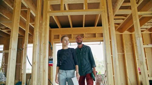 Two young people discussing the construction of a house inside the house. Medium shot. Soft focus
