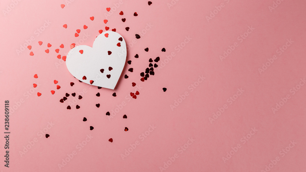 Creative photo. Valentine's Day postcard. Valentine's Day Background. Heart with confetti on pink background. Copy space. Top view. Flat lay. Pastel colors